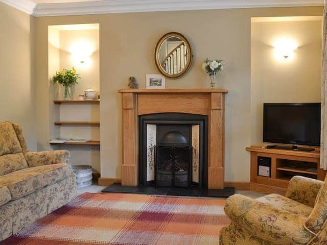 Lounge area with open fire | Peg&rsquo;s Place, Bowness-on-Windermere