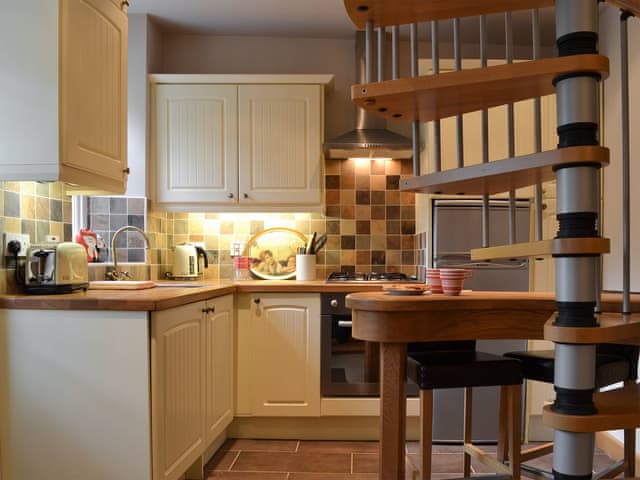 Kitchen area with spiral stairs | Peg&rsquo;s Place, Bowness-on-Windermere