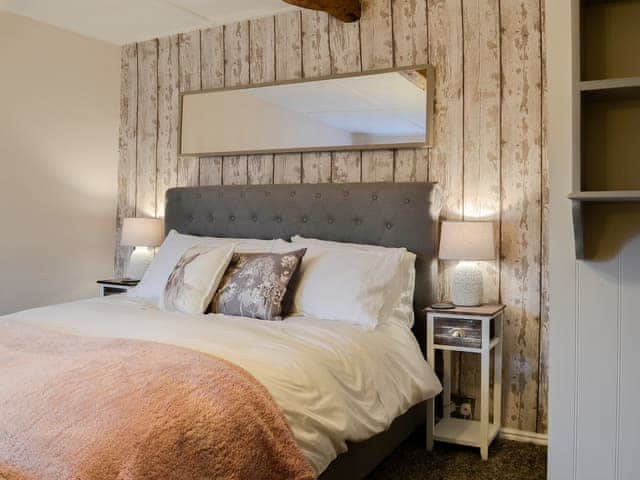 Beamed bedroom with a king sized bed | Thorpe Cottage, Masham