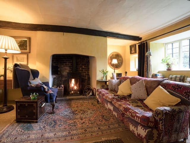 Cosy living room with wood burner | The Old Priory Cottage, Dunster, near Minehead