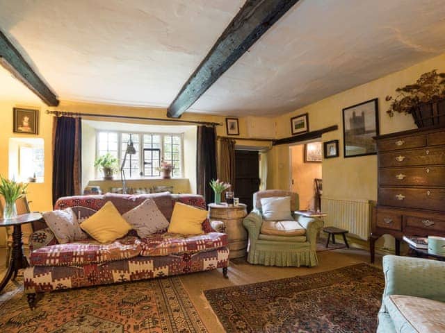 Cosy living room with wood burner | The Old Priory Cottage, Dunster, near Minehead