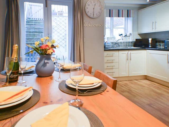 Dining and adjacent kitchen | Endeavour Cottage, Whitby