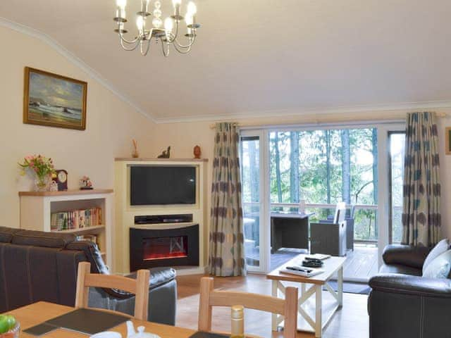 Comfortable living area with doors to the veranda | Oak Lodge, Clatworthy, near Williton