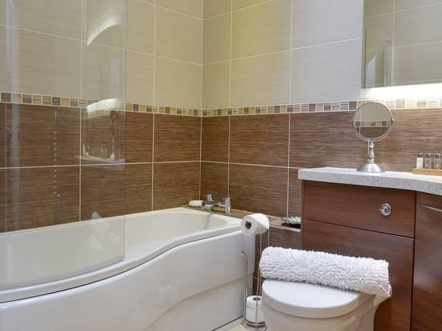 Family bathroom with shower over bath | Applegate Cottage - Holtby Grange Cottages, Holtby, near York