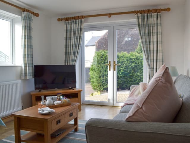 Living room with patio doors | Miners Cottage, Clowne, near Chesterfield