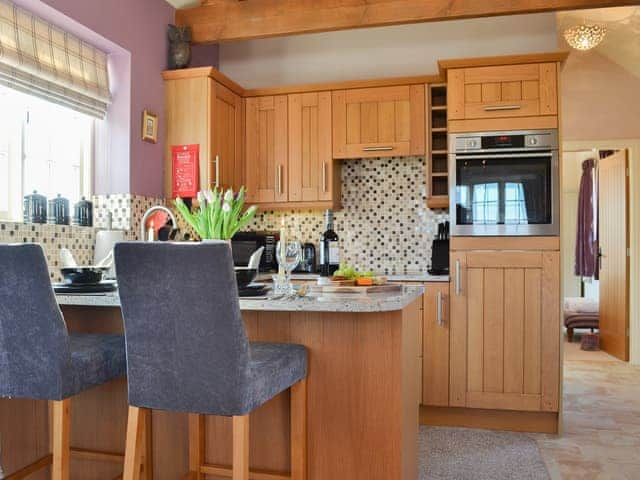 Modest kitchen with granite-topped breakfast bar | Cozy Cottage - Holtby Grange Cottages, Holtby, near York