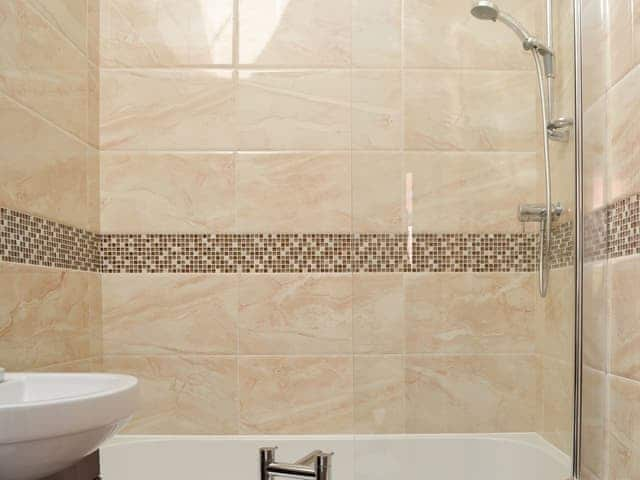 Beautifully tiled bathroom with shower over the bath | Cozy Cottage - Holtby Grange Cottages, Holtby, near York