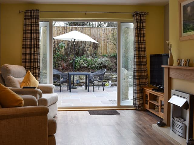 Living room with patio doors | Old Orchard Cottage, Trethurgy, near St Austell