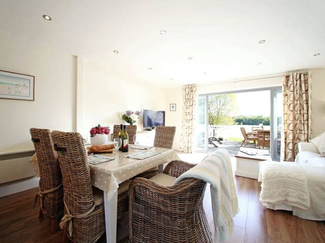 Living room with dining area | Coot Lake House, Cotswold Lakes