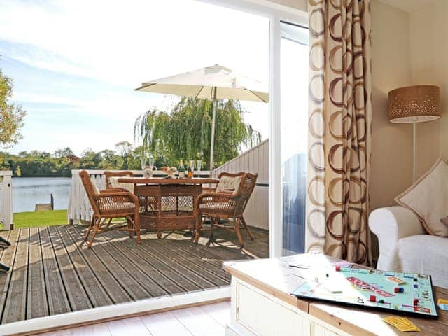 Living room with patio doors | Coot Lake House, Cotswold Lakes