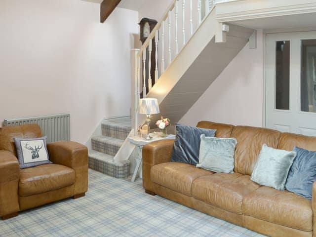 Stylish living area with stairs to mezzanine | The Old Telephone Exchange, Rothbury