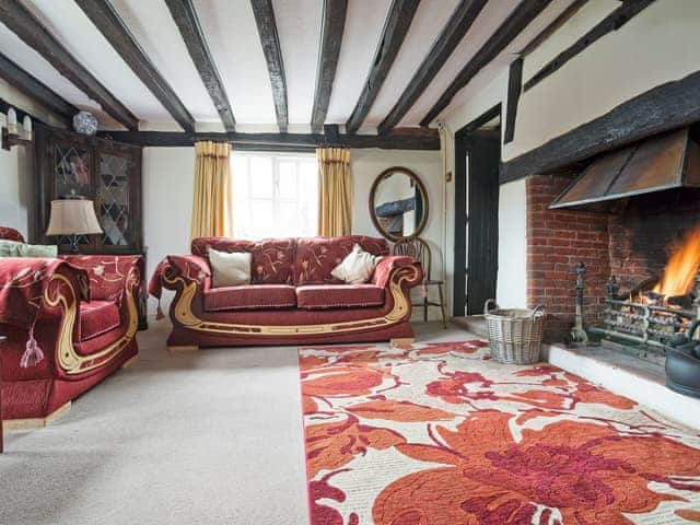 Impressive living room with open fire | Yew Tree Cottage, Moulsoe, near Milton Keynes