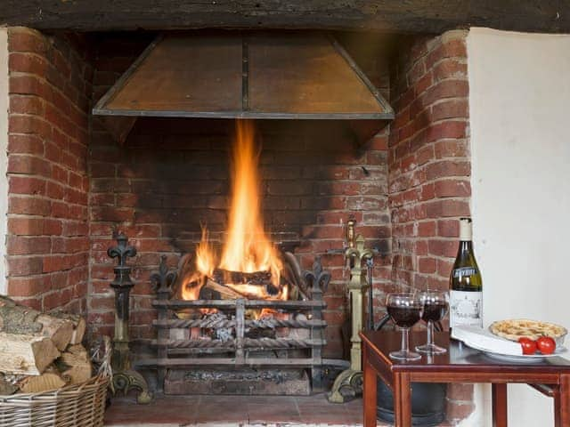 Impressive living room with open fire | Yew Tree Cottage, Moulsoe, near Milton Keynes