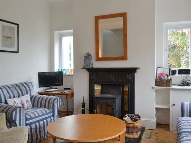 Living room with woodburner and open fireplace | Beech Cottage, St Lawrence, near Ventnor