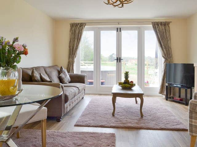 Stylish living area with French doors to patio | Hare&rsquo;s Home - Thursford Holidays, Thursford, near Fakenham