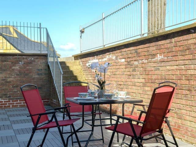 Enclosed sitting-out area with garden furniture | The Hideaway, Sleights, near Whitby