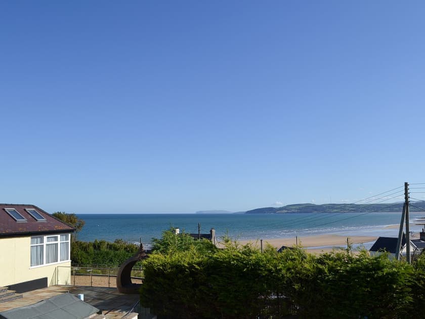 Panoramic views from lounge window over Benllech bay towards Puffin Island and Llandudno Great Orme | Beach Cottage, Benllech
