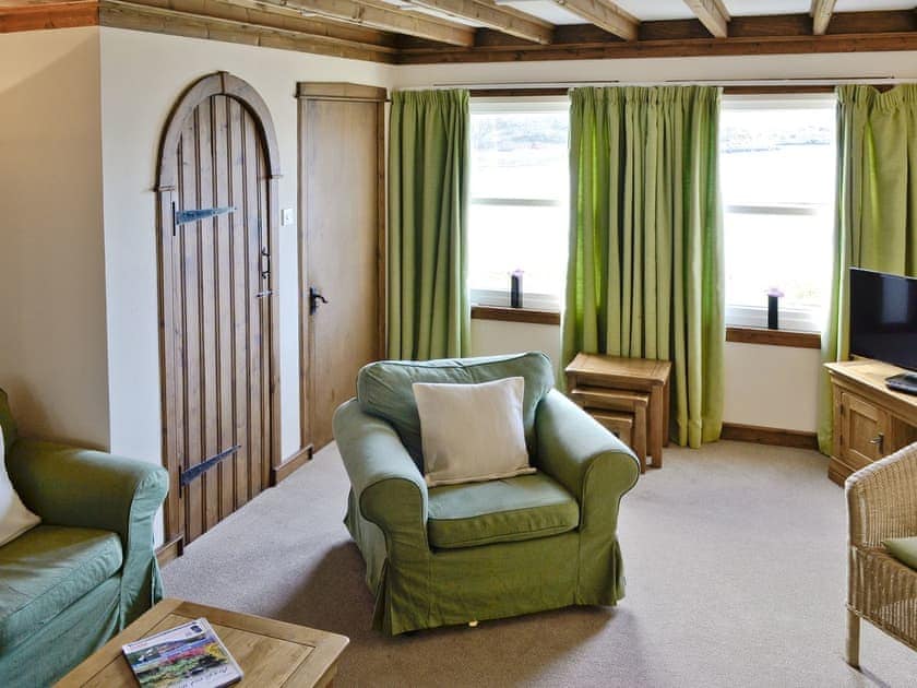 Living area with exposed wood beams | Shuna - Craobh Marina Cottages, Craobh Haven, by Oban