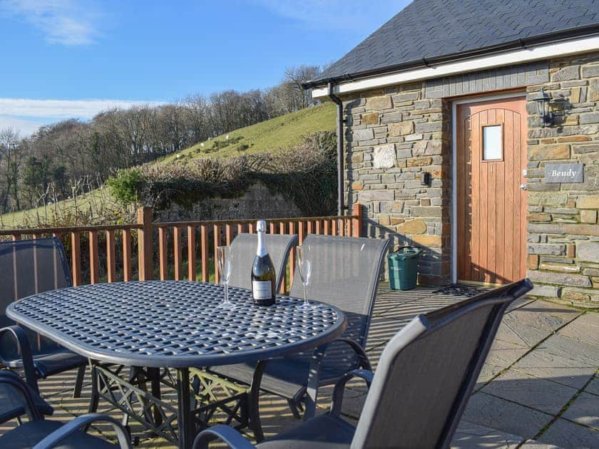 Wonderful outdoor seating area with table and chairs | Beudy - Bwlch Y Person Barns, Dihewyd, near Aberaeron