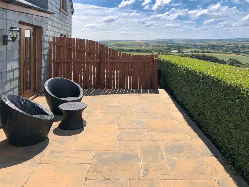 Patio with delightful views | Dewdrop Dairy - Wooldown Holiday Cottages, Marhamchurch, near Bude