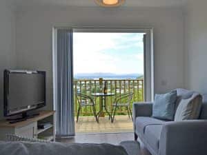 Comfortable living area with French doors leading to terrace | Sealladh Alainn, Oban