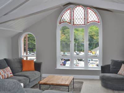 The huge floor to ceiling arched window in the lving area affords views of the river | St Monicas, Fowey