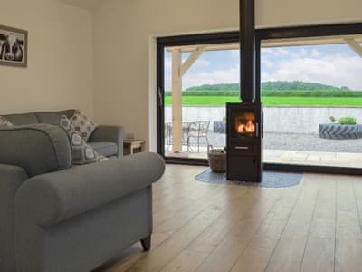 Wonderful living area with cosy wood burner | Taters Barn, Aikton, near Wigton