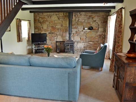 Tastefully furnished living area with wood burner | Barncott - Trewellard Manor Farm, Trewellard, near Penzance