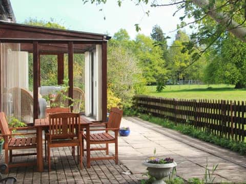 Delightful patio area with conservatory | Foresters Cottage, Tarbat, Invergordon