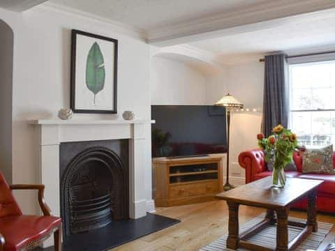 Delightful living room with an open fire | The Town House, Wimborne