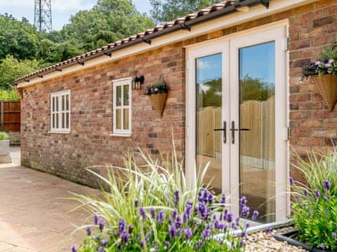 Second patio area at rear of property | Woodcutters Cottage - Bray Holiday Cottages, Fulletby, near Horncastle