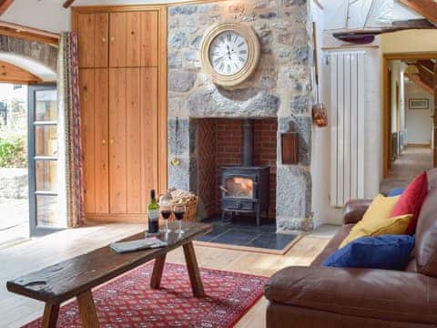 Lovely living room with feature fireplace | The Byre - Lyserry Barns, Bosherston, near Pembroke