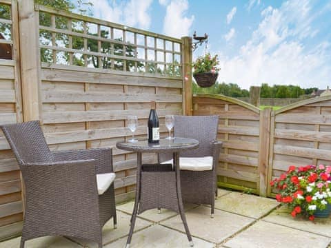 Courtyard with sitting-out area and garden furniture | Eagles Cottage, Corston, near Malmesbury