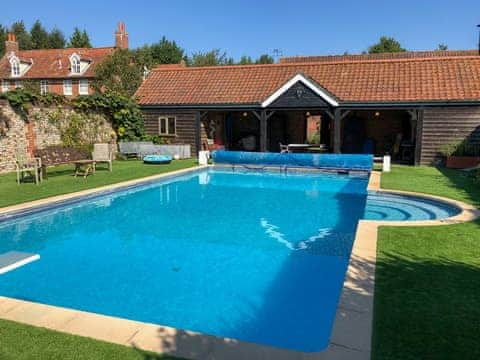 Shared outdoor heated swimming pool | Orchard House, Hempstead, near Holt