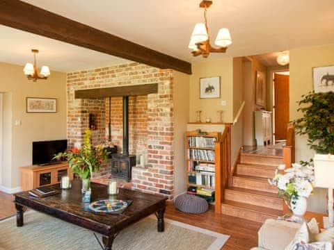 Comfortable living room with wood burning stove | The Hayloft - Marshwood Manor Cottages, Bettiscombe, near Lyme Regis