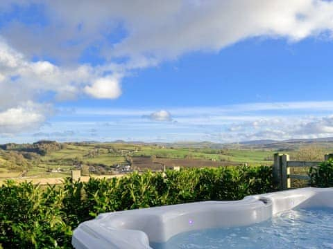 Relax and take in the spectacular view from the hot tub | The Barn, Gwyddelwern near Corwen