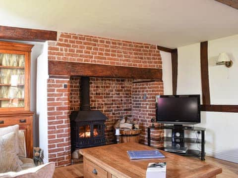 Living room with wood burner | Brushmaker Cottage, Diss