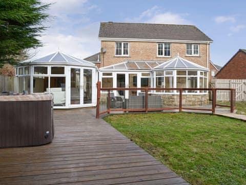 Luxurious hot tub on the decking within the rear garden | West Fells Cottage, Rowrah, near Frizington