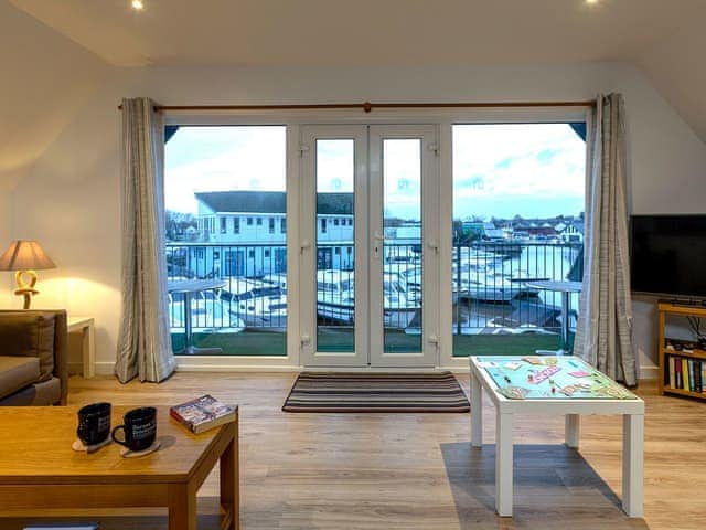 Spacious living room with French doors to balcony | Heron - Daisy Broad Lodges, Wroxham