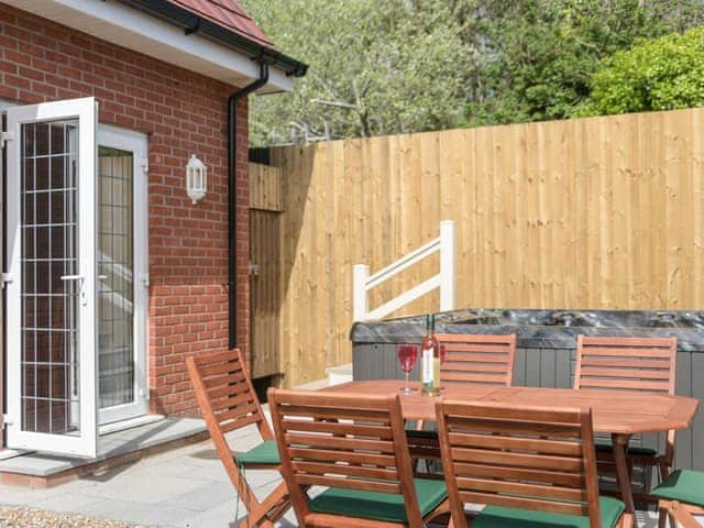 Hot tub and seating area | Beach Lodge, Winthorpe