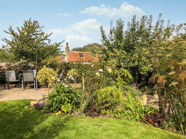 Lawned garden with raised seating area | Rose Cottage, Fylingthorpe, near Whitby
