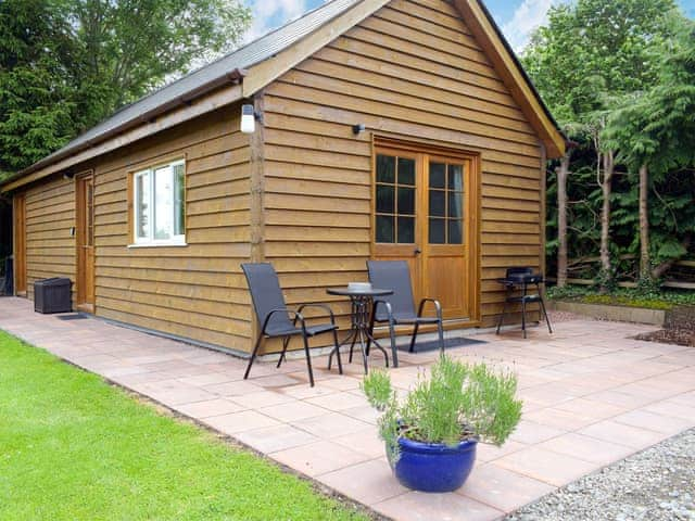 Patio with garden furniture and barbecue | Walkers Lodge, Dormington, near Hereford