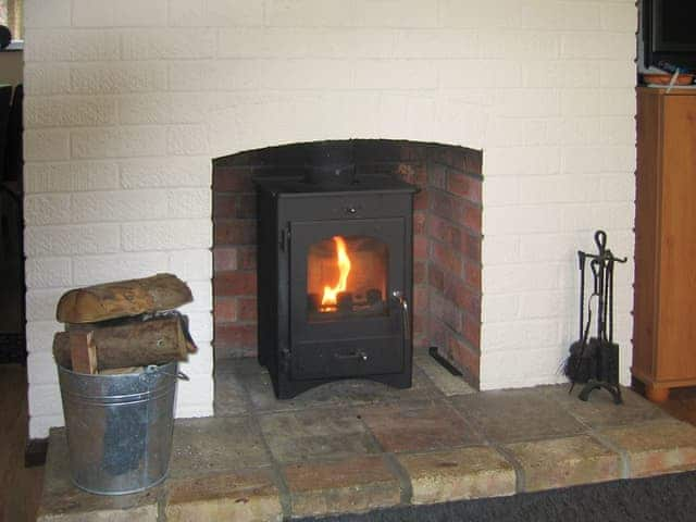 Warming wood burner within living room | Wallages Cottage - White House Farm Holiday Cottages, Knapton, near North Walsham