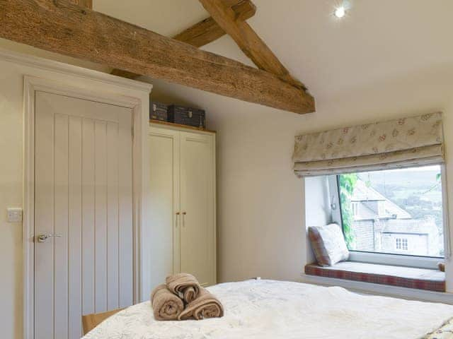 Characterful exposed wood beams within the en-suite double bedroom | Easter Cottage, Bamford, near Hope Valley