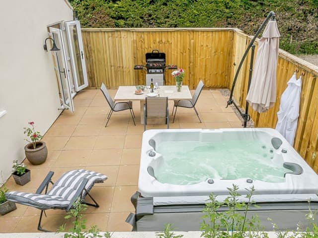 Large enclosed terrace with sitting-out area, garden furniture and gas BBQ | Wits End Cottage, Roughton, near Woodhall Spa