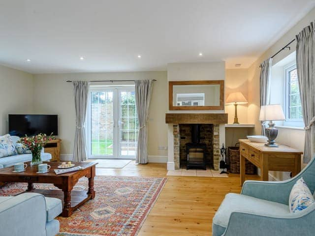 Comfortable bedroom with wood burner | Sea Lavender Cottage - Hall Lane Cottages, Thornham, near Kings Lynn