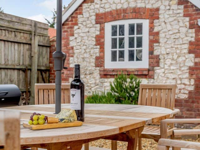 Enclosed courtyard with sun deck, garden furniture and BBQ | Sea Lavender Cottage - Hall Lane Cottages, Thornham, near Kings Lynn