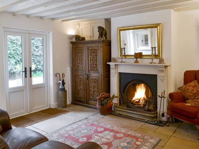 Additional seating area with open fire | Walnut Tree House, Tilney St Lawrence, near Kings Lynn