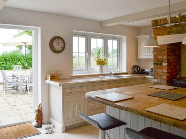 Well-equipped kitchen with door to patio | Walnut Tree House, Tilney St Lawrence, near Kings Lynn