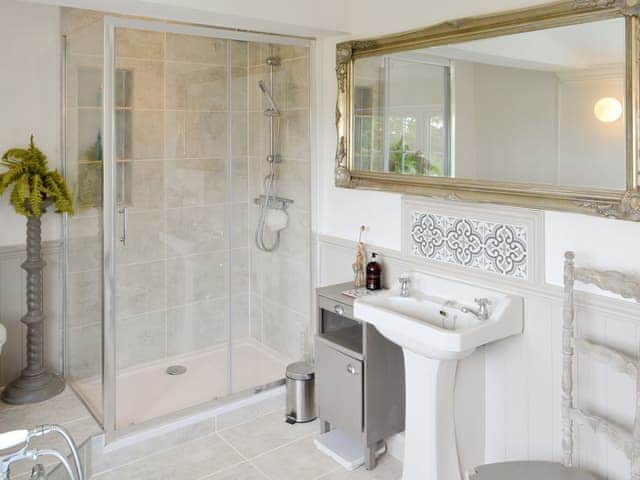 Bathroom with large shower enclosure and roll-top bath | Walnut Tree House, Tilney St Lawrence, near Kings Lynn